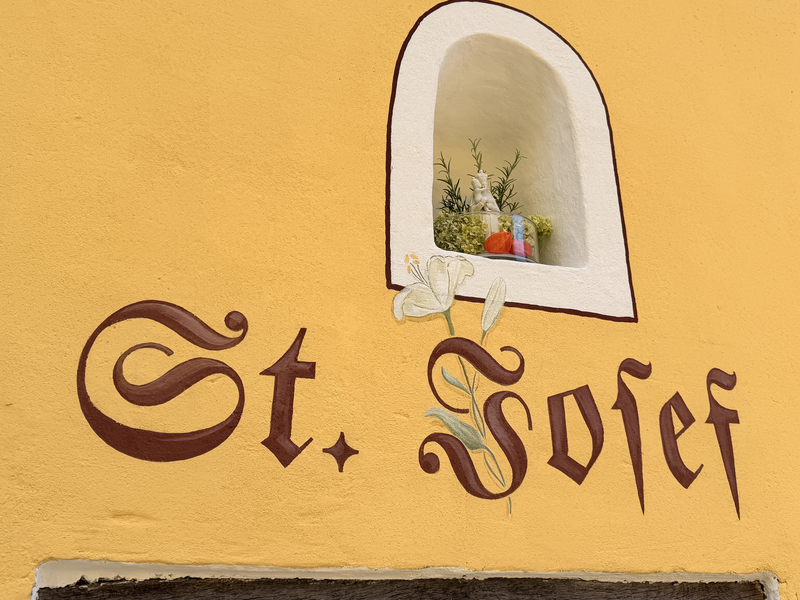 Weihung der Kapelle Beigarten, man sieht den Schriftzug St. Josef auf gelben Putz.